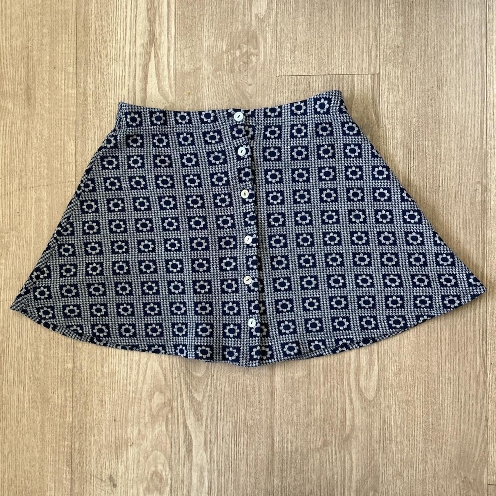 Navy floral print skirt that buttons up in the front.